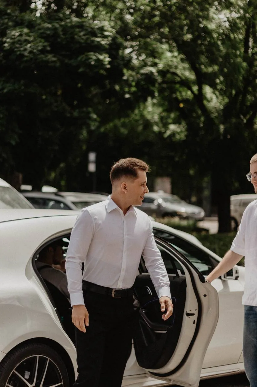 Driver opening the car door for a client